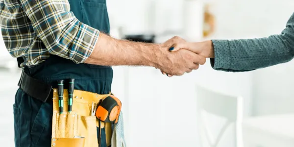 A man shaking hands with another person.