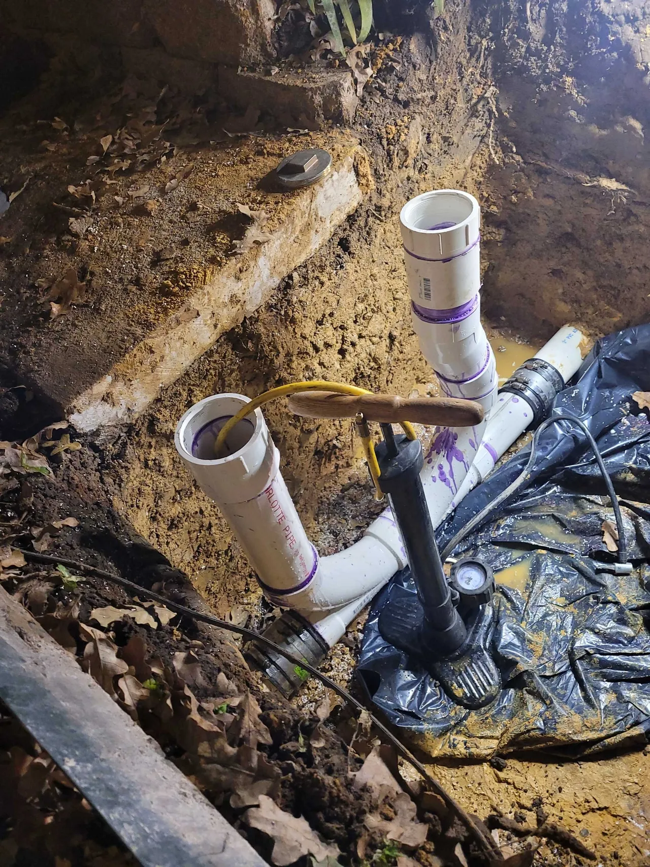 A pipe laying on top of a pile of dirt.