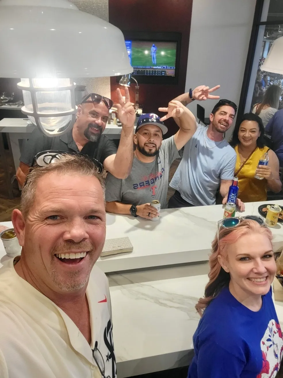 A group of people sitting at a table with drinks.